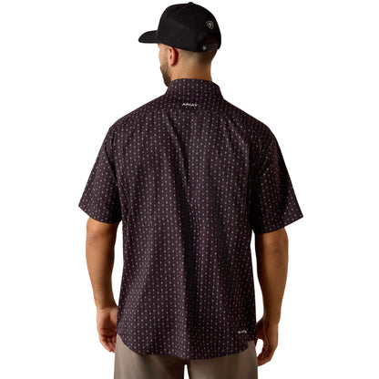 Man wearing a patterned shirt and cap on a white background