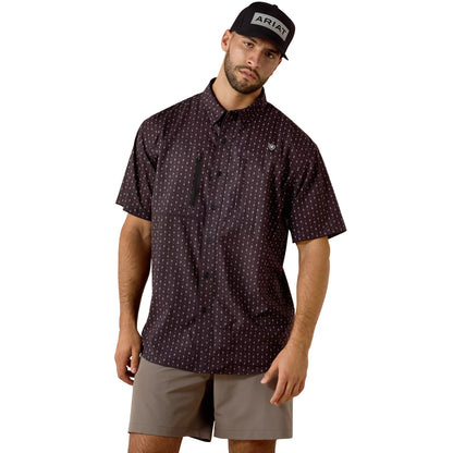Man wearing a patterned shirt and cap with 'Ariat' branding on a white background