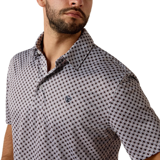Man wearing a patterned short-sleeve shirt on a white background