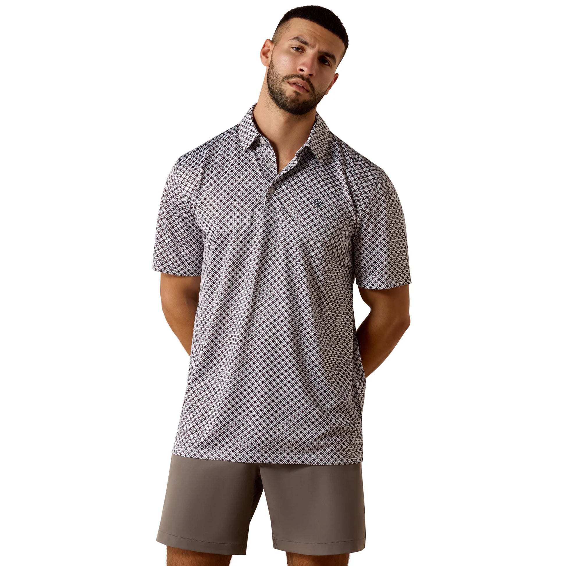 Man wearing a patterned polo shirt and shorts on a white background