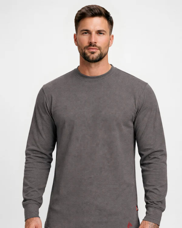 Man wearing a gray long-sleeve shirt against a white background