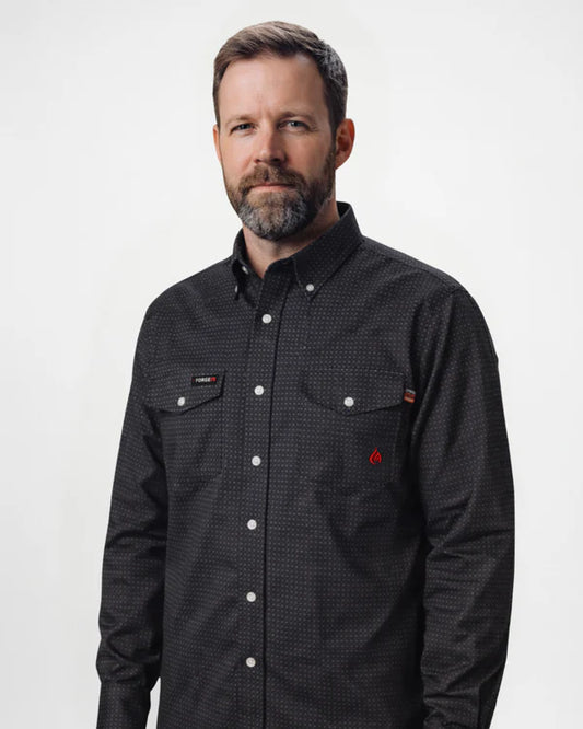 Man wearing a black checkered shirt with a brand logo on a white background