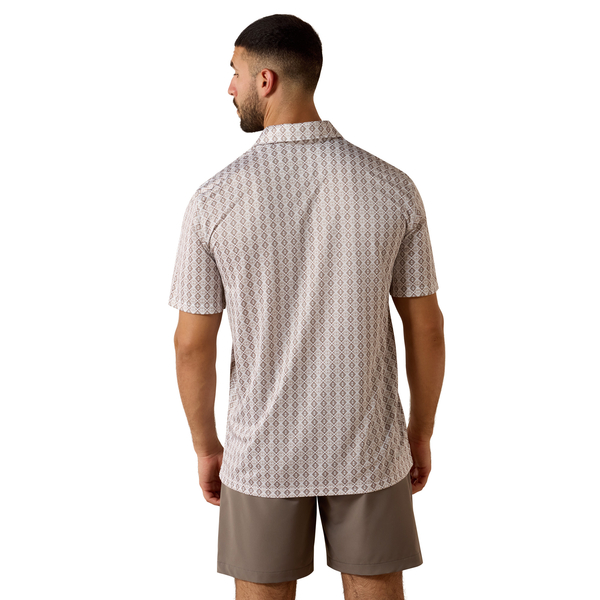Man wearing a patterned shirt and beige shorts on a white background