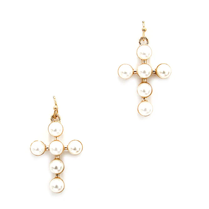 Gold and pearl earrings on a white background