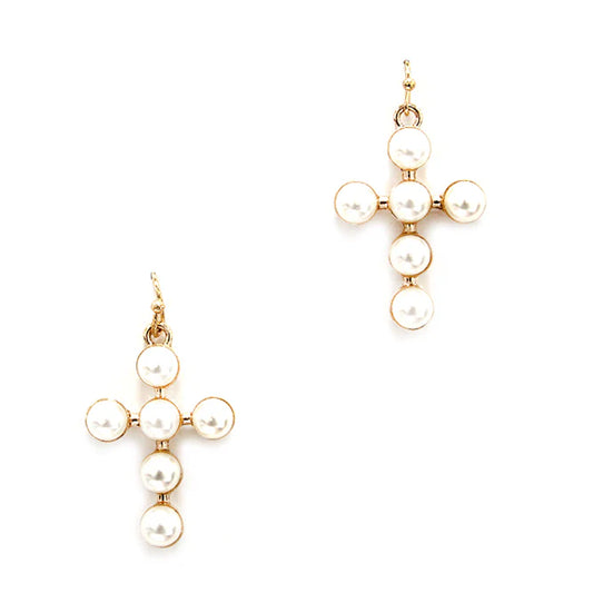 Gold and pearl earrings on a white background