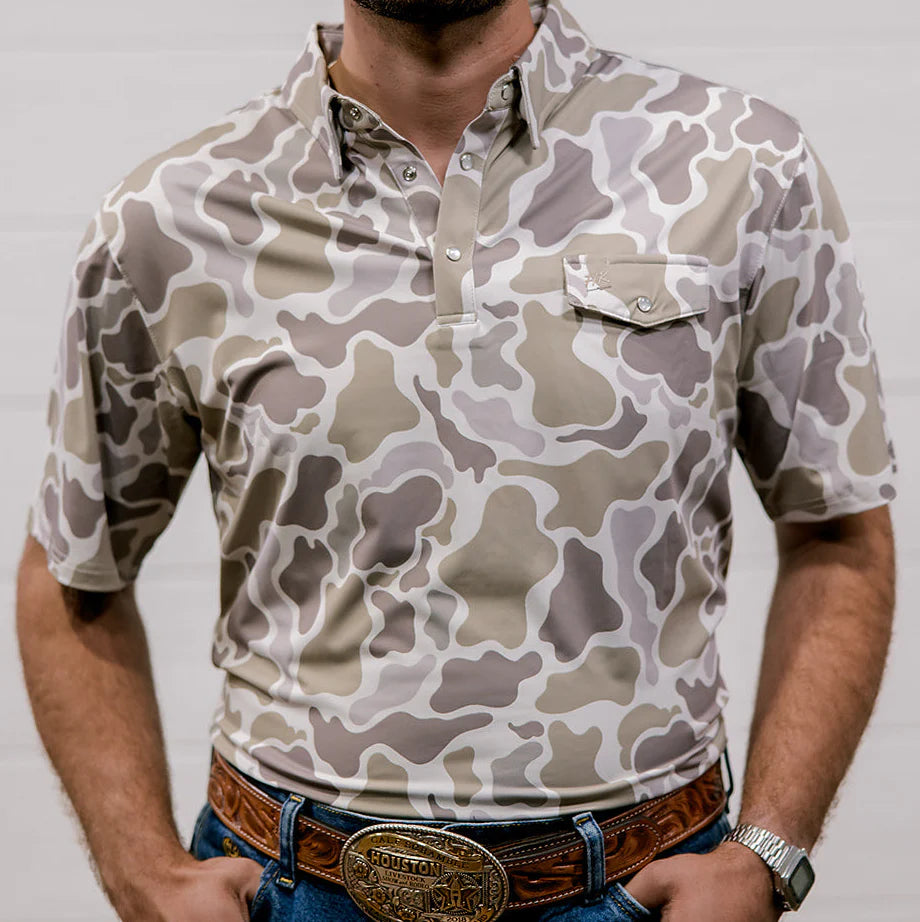Person wearing a camouflage-patterned shirt with a plain background