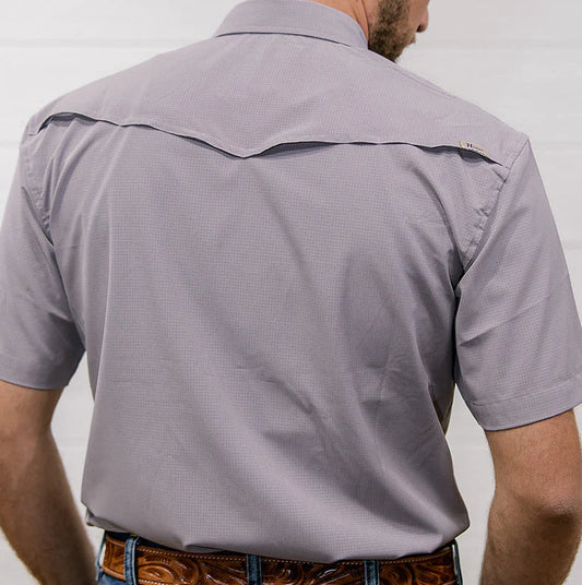 Man wearing a gray short-sleeve shirt with a subtle pattern against a plain background