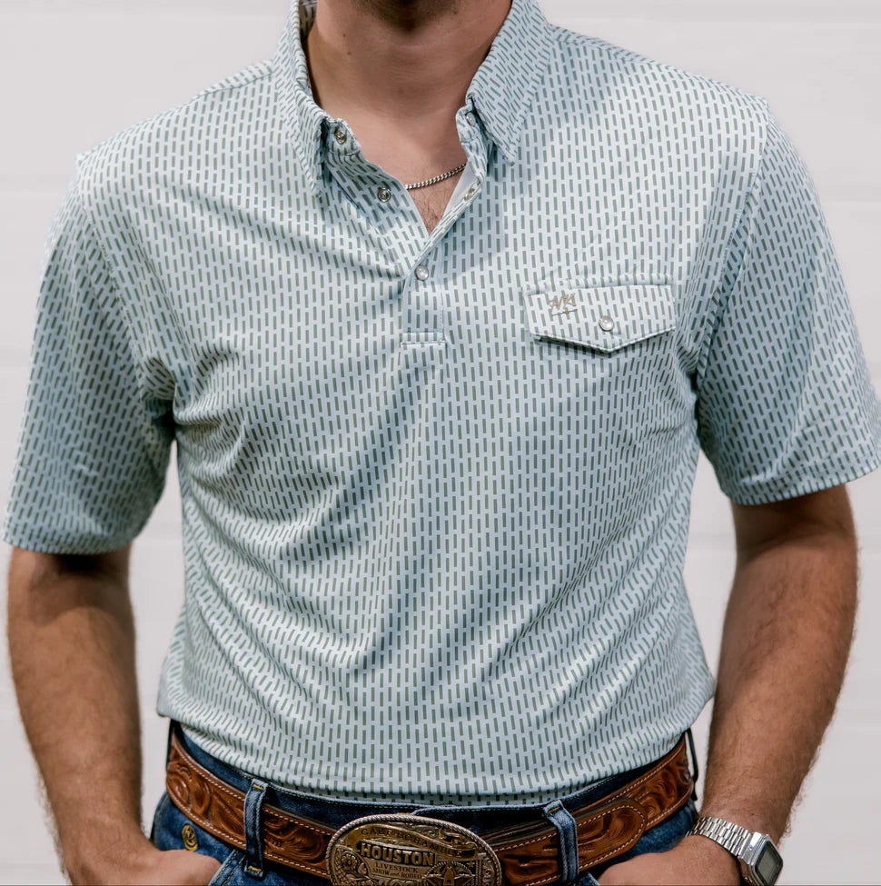 Man wearing a patterned short-sleeve shirt with a plain background
