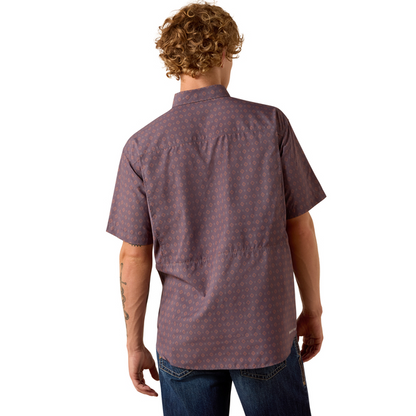 Man wearing a patterned short-sleeve shirt on a white background