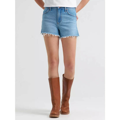 Person wearing blue denim shorts and brown knee-high boots on a white background