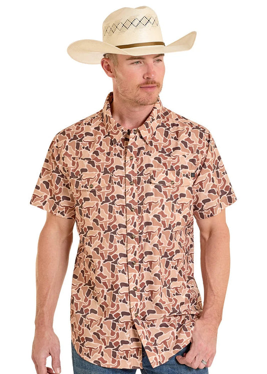 Man wearing a patterned shirt and cowboy hat on a white background