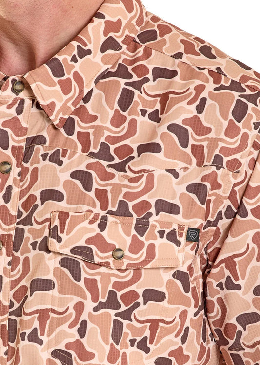 Close-up of a camouflage-patterned shirt with a visible brand logo.