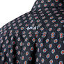 Close-up of black patterned shirt with small red and white floral motifs and embroidered text.