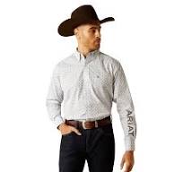 Man in cowboy hat wearing a button-down print shirt with ARIAT logo, and dark jeans.