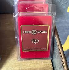 Red Circle Candles wax melts in clear packaging on a wooden surface