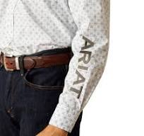 Man wearing patterned long sleeve Ariat shirt, brown belt, and dark jeans