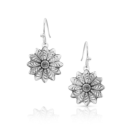 Pair of silver floral earrings on a white background