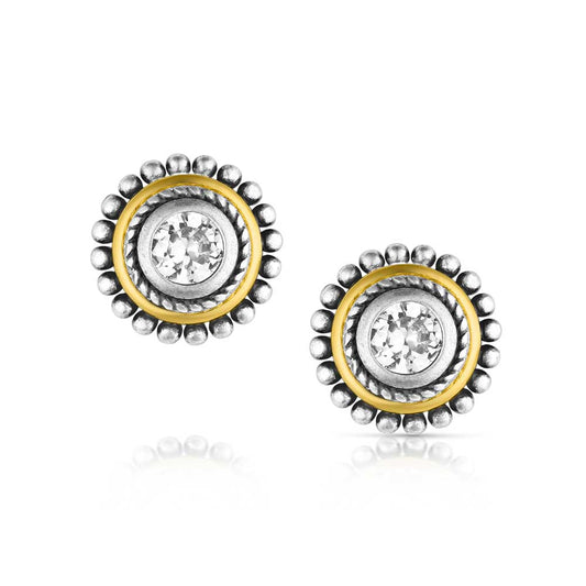 Pair of silver and gold earrings with clear gemstones on a white background