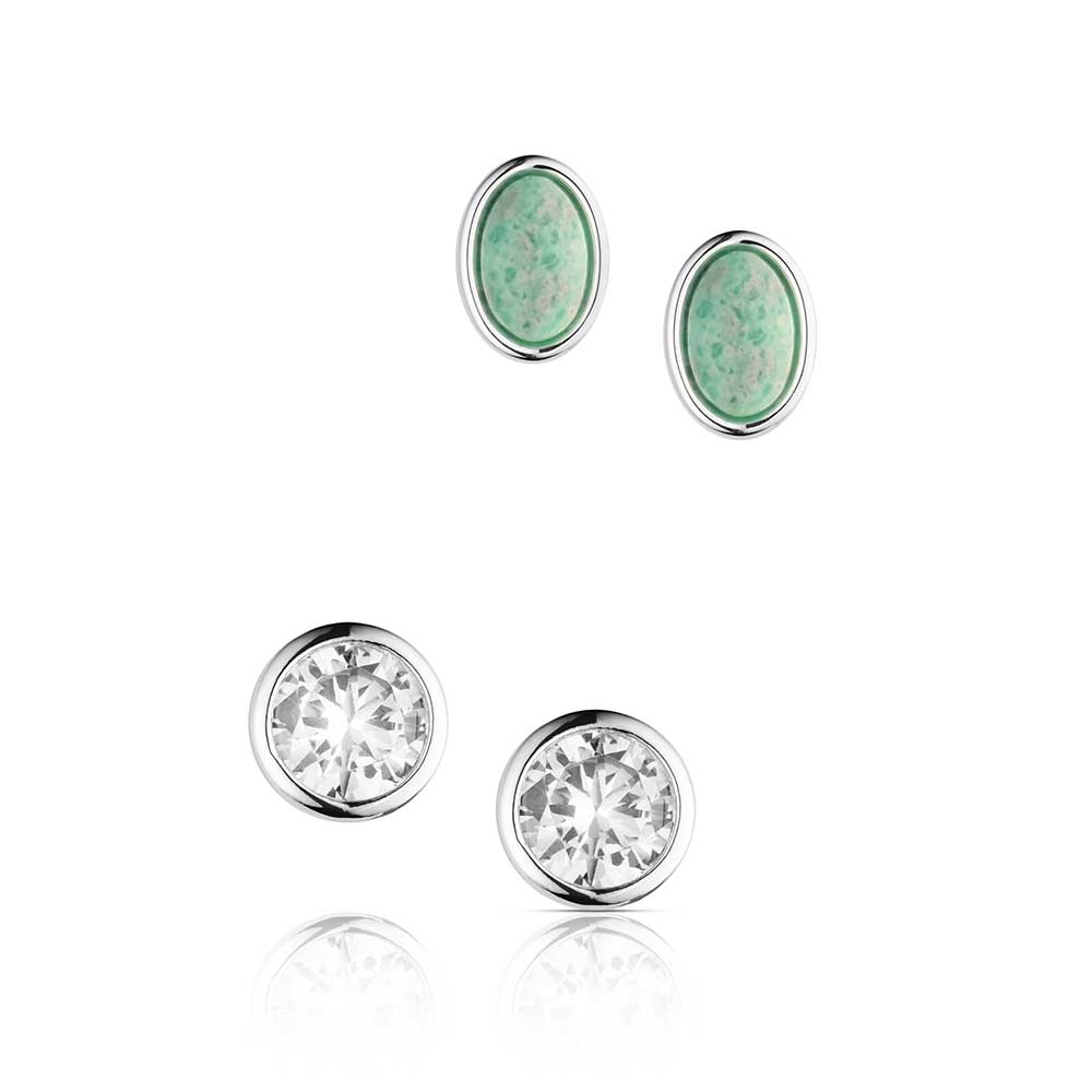 Pair of earrings with green gemstones and clear crystals on a white background