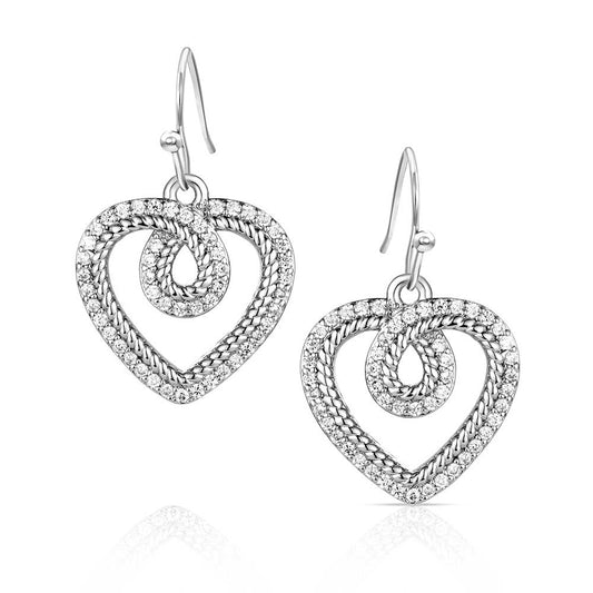 Silver heart-shaped earrings with intricate designs on a white background