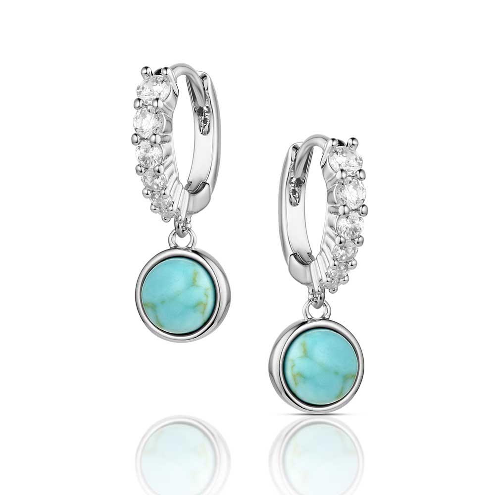 Silver hoop earrings with turquoise stones on a white background