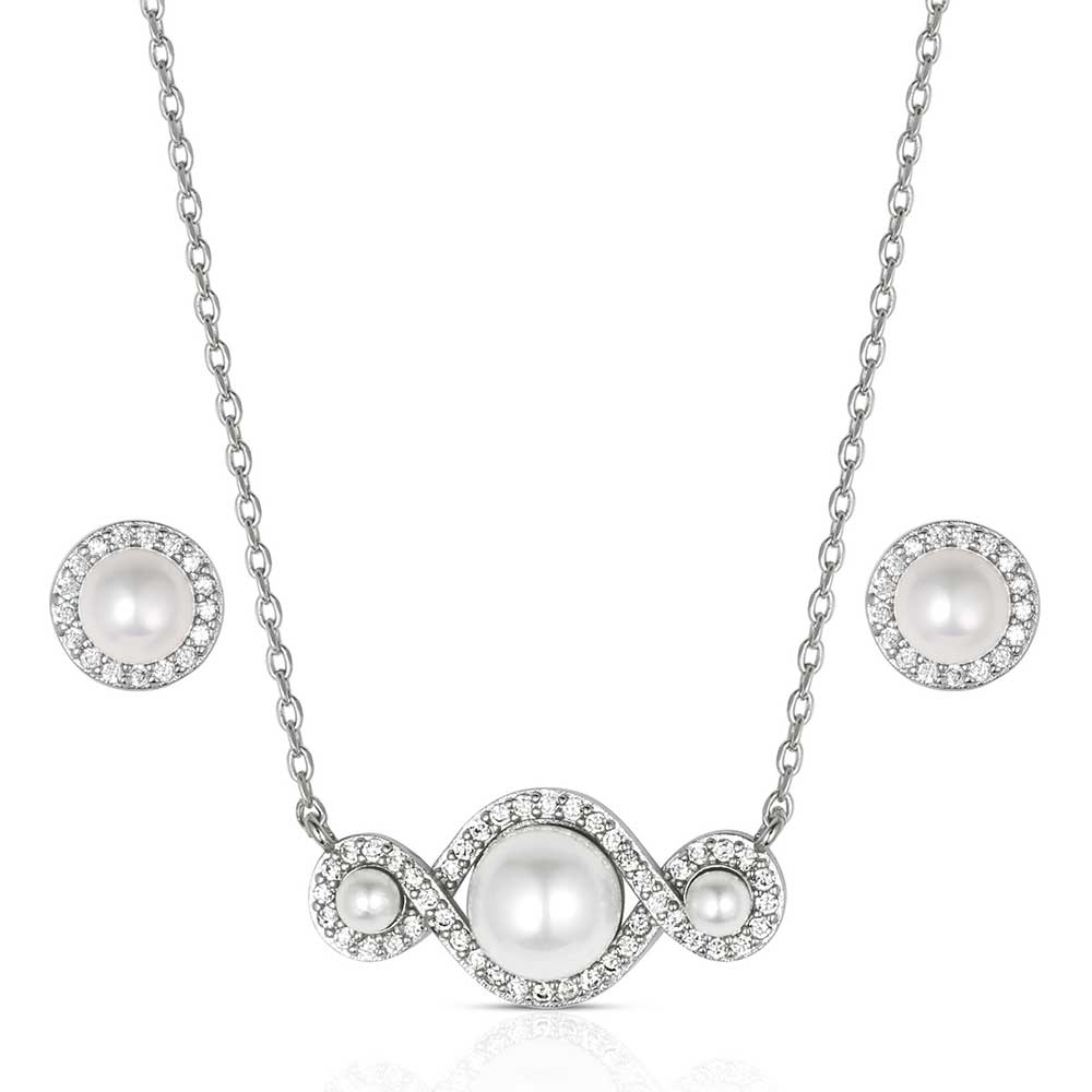 Pearl necklace and earrings set on a white background