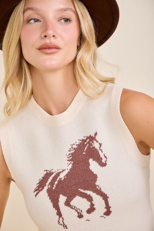 Woman in brown hat wearing cream sleeveless knit top with horse graphic, western style