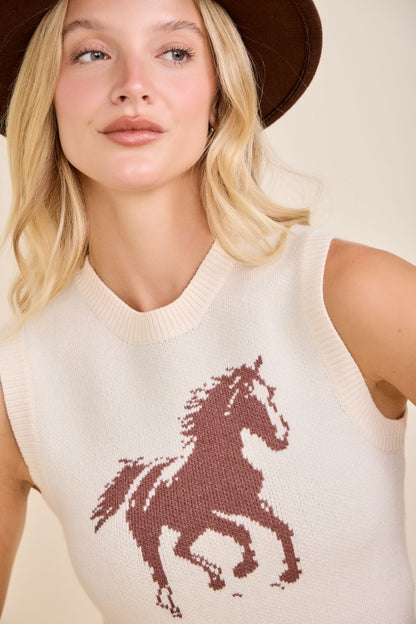 Woman in brown hat wearing cream sleeveless knit top with horse graphic, western style