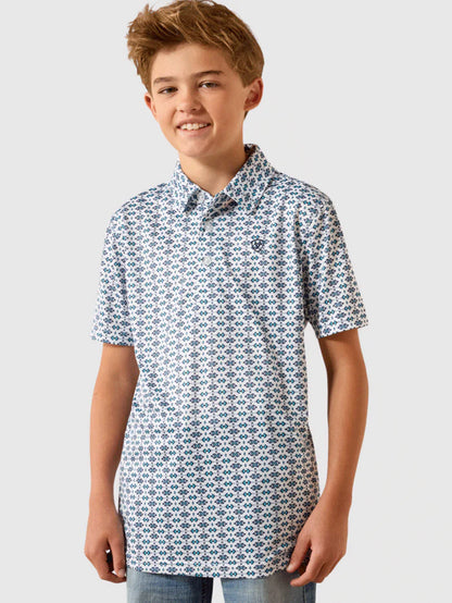 Boy wearing a short sleeve patterned polo shirt with blue geometric print and light jeans