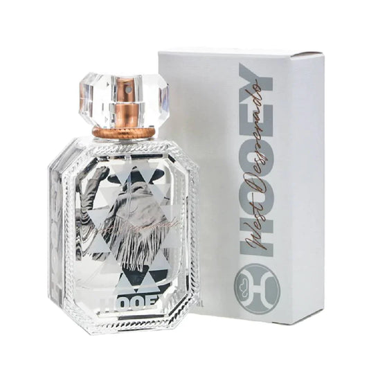 Perfume bottle with decorative label and matching box on a white background