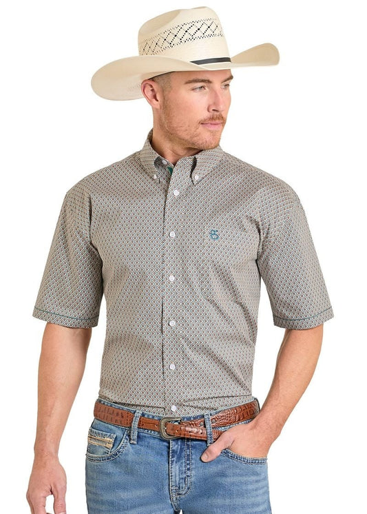Man wearing a patterned short-sleeve shirt, jeans, and a cowboy hat on a white background