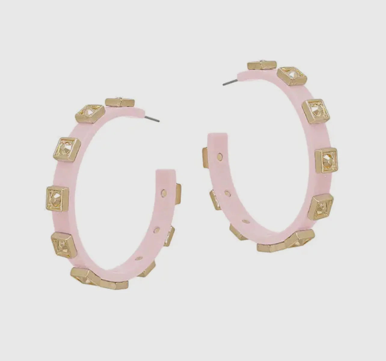 Pink studded hoop earrings with gold square accents on a white background